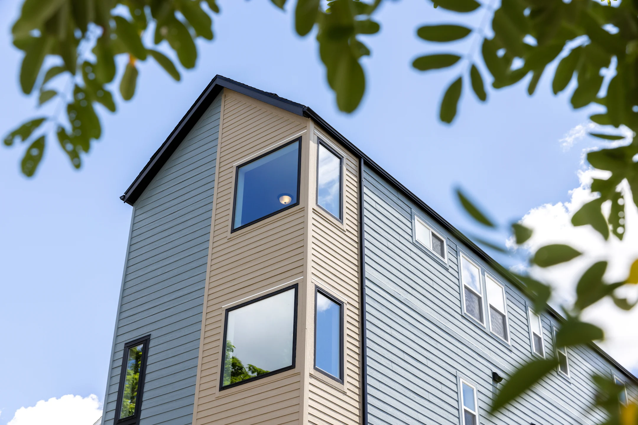 Two-story home with black and brown LP siding