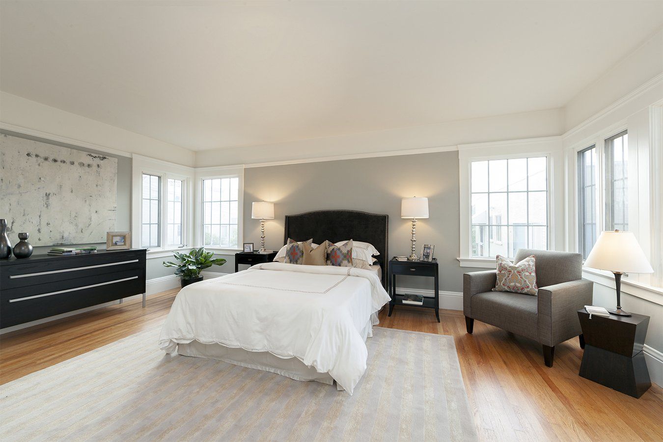 Bright bedroom with white gridded windows on two walls