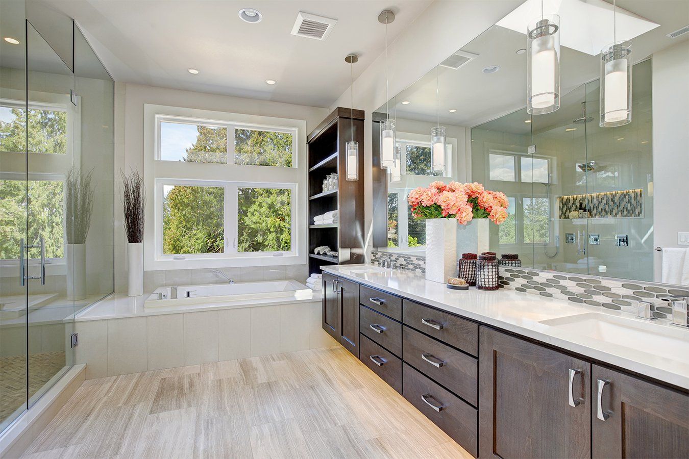 Bathroom with white windows above a bathtub and leafy views outside